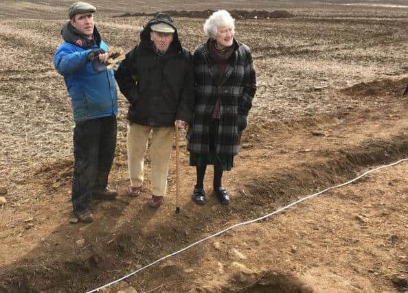 Martin Fiennes shows his parents, Lord and Lady Saye and Sele, the progress of the trial dig at the site of the Roman Villa in 2019