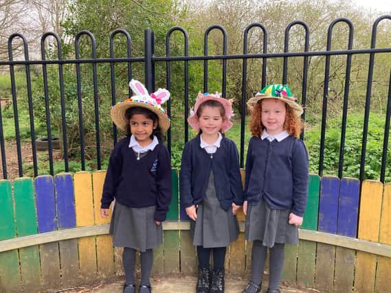 Three pupils - Gloria Rendage, 5, Sienna Standen, 5, and Florence Jones, 4 - from Harriers Academy Banbury wearing their decorated Easter bonnetts (Image from Harriers Academy Banbury)