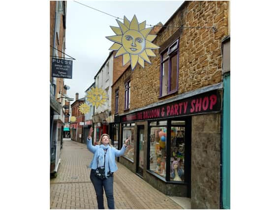Yolanda Fletcher, the manager of the Banbury BID, points out some of the icons of Banbury BID the sunshine symbols placed around the town centre