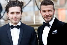 Birthday boy Brooklyn Beckham with his dad, David. Picture by Getty Images