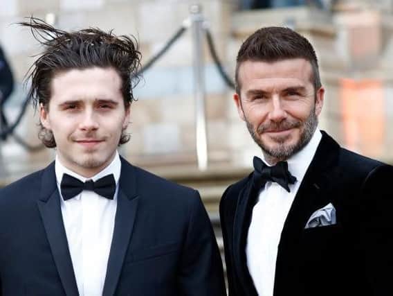Birthday boy Brooklyn Beckham with his dad, David. Picture by Getty Images