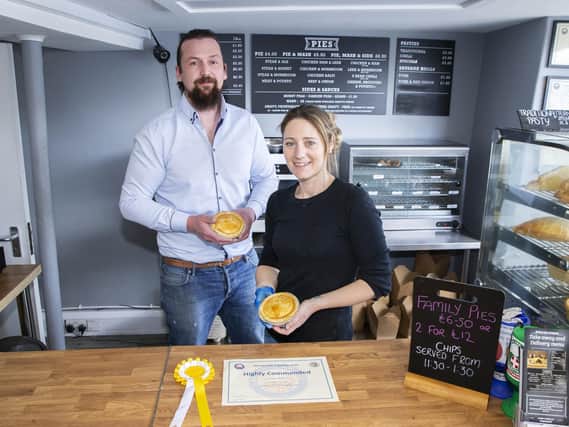 David Butler, owner of the Butler's Pie Company, and staff member Shona Adams hold some of their award winning pies