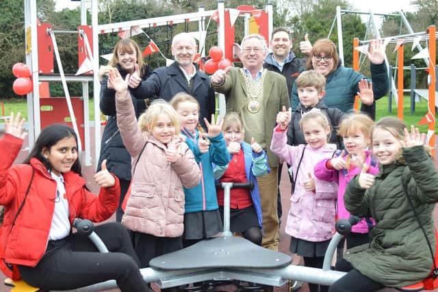 Banbury Town Mayor Cllr John Colegrave joins teachers Sarah Moon and Caroline Debus, Steve Sylvester (managing director of equipment manufacturers Kompan), Thomas Griffiths (area sales manager Kompan), and the pupils at the play area opening.