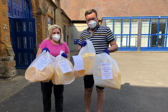 Volunteers from Winchester House School in Brackley hold up bags of face shields to be delivered to key workers and health workers
