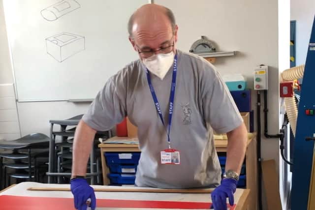 A volunteer Winchester House School makes a face shield for key workers and health professionals