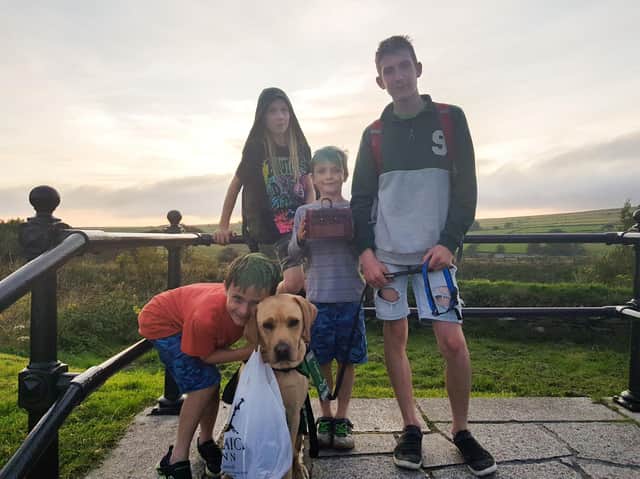 Ty and his assistance dog Denby and Ty's brothers Jude, Ethan and Jacob