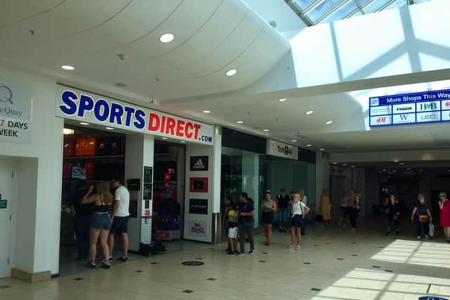 A dozen or so people waited in a que to get into Sports Direct at the Castle Quay Shopping Centre on Monday June 15 as non-essential retail shops reopened across the UK