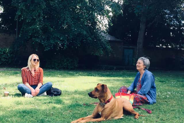 Mother and daughter, Claire and MaryBell, with pet Flow enjoying a socially distance time sitting on the grass at the park inBanbury.(photo by Banbury XR member,Tila Rodriguez Past)