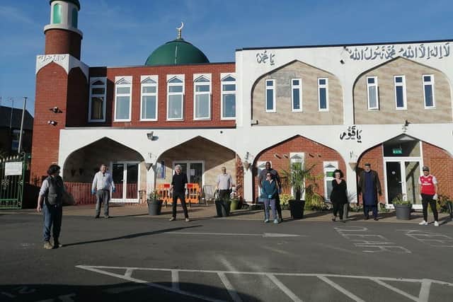Volunteers stand outside the Banbury Mosque during the lockdown