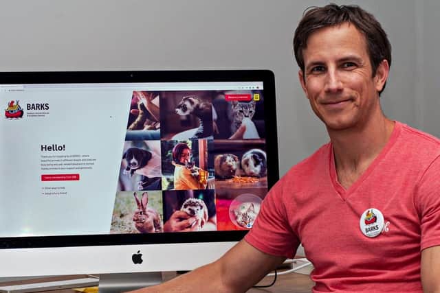 Digital designer Nic Warrington with the home page of the new BARKS website he created (photo from the BARKS charity)