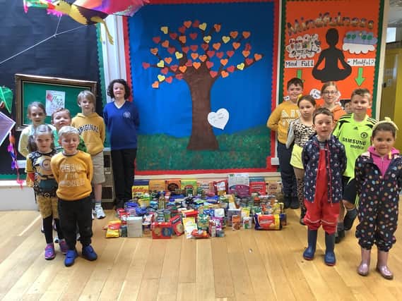 The Wroxton Primary School council stands proudly with the school's donations for the local area food bank from the autumn harvest service. (Submitted photo from Wroxton Primary)