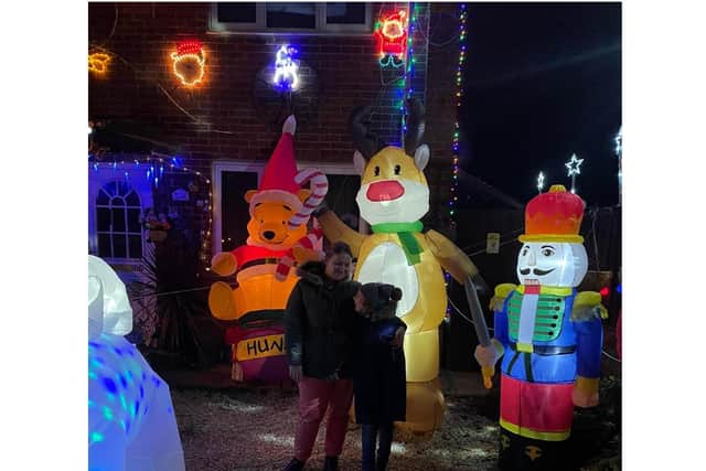 Kylie Hill and her son Jasper outside their family Christmas light display near Bretch Hill Banbury