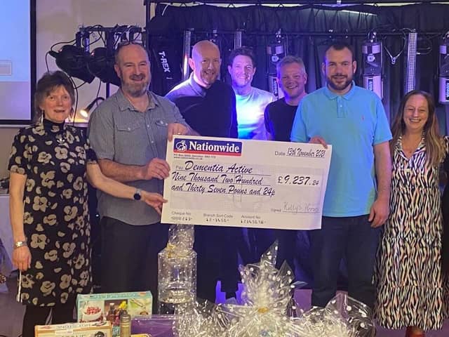 Andrew Gill and Melissa Fazackerley with Dementia Active the Banbury-based charity, and a few members of Kelly’s Heroes, who presented the charity with the cheque.