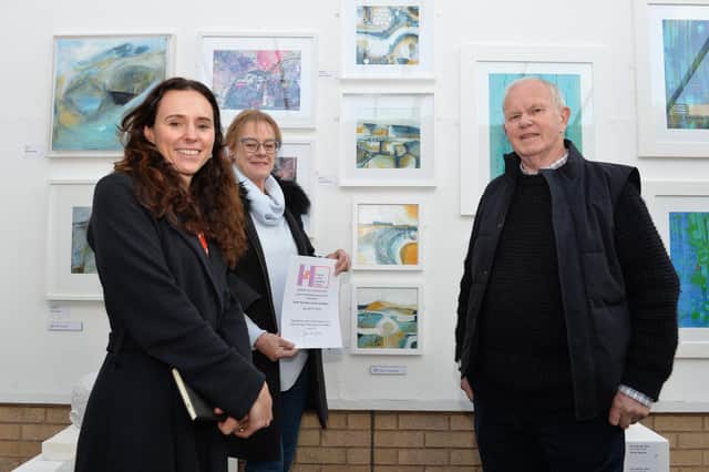 Sarah B Smith with her mixed media paintings are selectors Deborah Allan, Director of Wychwood Gallery, and John Childs, Patron of the Friends of the Heseltine Gallery. Picture by Geoff Carverhill