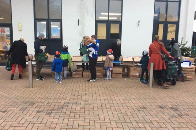 Families from Dashwood Academy collect meals delivered by The Caring Family Foundation on Friday December 17