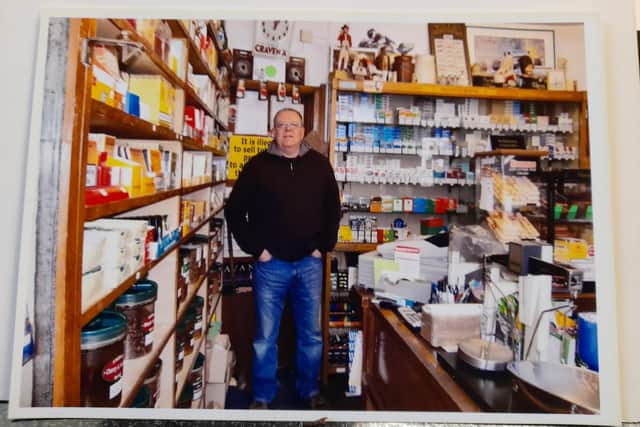 John Cousins stands behind the counter inside his shop the Banbury Cross Tobacco Stores several years ago