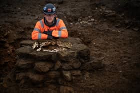 James West, Site Manager MOLA, by one of four wells uncovered during the archaeological excavation of a wealthy Roman trading settlement, known as Blackgrounds