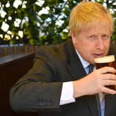 Boris Johnson, in happier times, drinking a pint of beer on a regional visit to the Midlands. Picture by Getty