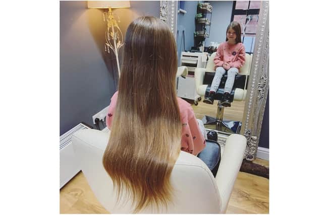 Darcie May, aged 8, grew her hair like 'Rapunzel' and decided to have it cut off to donate it to the Little Princess Trust charity as part of a charity fundraiser. (photo with permission from the family)