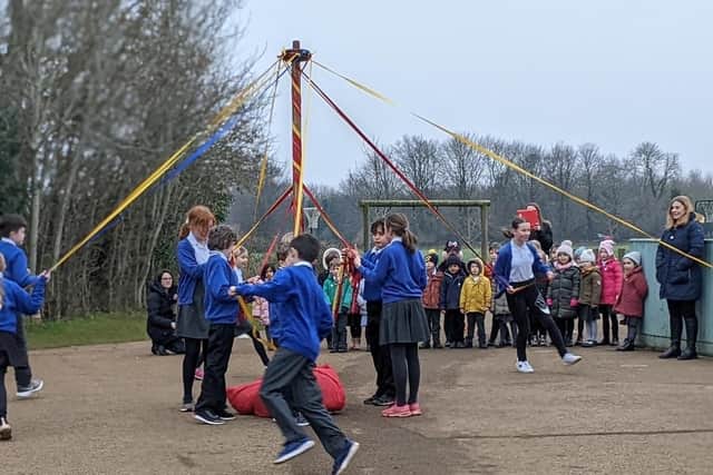 Wroxton Primary School pupils delight their Japanese guests with a display of maypole dancing