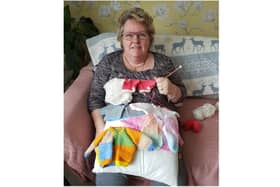 Linda Carnie knits some jumpers for babies born prematurely. She has spent decades caring for children and adults and is keen to recommend a scheme that has seen hundreds of people sharing their family and community life with someone who needs support. (photo from Oxfordshire County Council)
