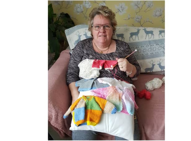 Linda Carnie knits some jumpers for babies born prematurely. She has spent decades caring for children and adults and is keen to recommend a scheme that has seen hundreds of people sharing their family and community life with someone who needs support. (photo from Oxfordshire County Council)