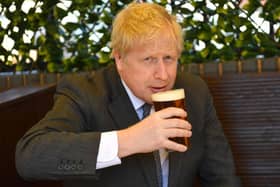 Boris Johnson enjoying a pint of beer. Library photo by Getty