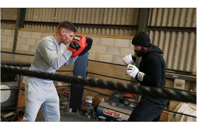Leo D’Erlanger, a professional boxer from Banbury, helps train Lee Williams for his 12-hour boxing challenge to benefit the charity Crohn's & Colitis UK (photo by Lee's son, Son Alfie Jack Williams)