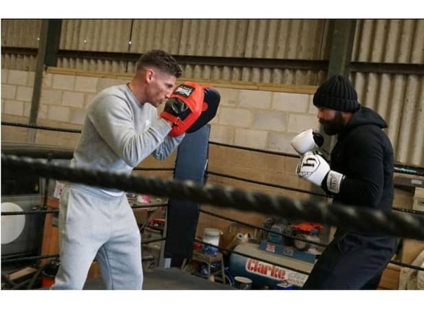 Leo D’Erlanger, a professional boxer from Banbury, helps train Lee Williams for his 12-hour boxing challenge to benefit the charity Crohn's & Colitis UK (photo by Lee's son, Son Alfie Jack Williams)
