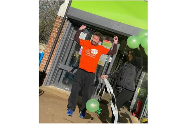 People gathered outside the King's Sutton Co-op to cheer on Jon Clayton-Fish as he crossed the finish line of his 40-mile challenge for charity on Monday January 31st (Submitted photo)