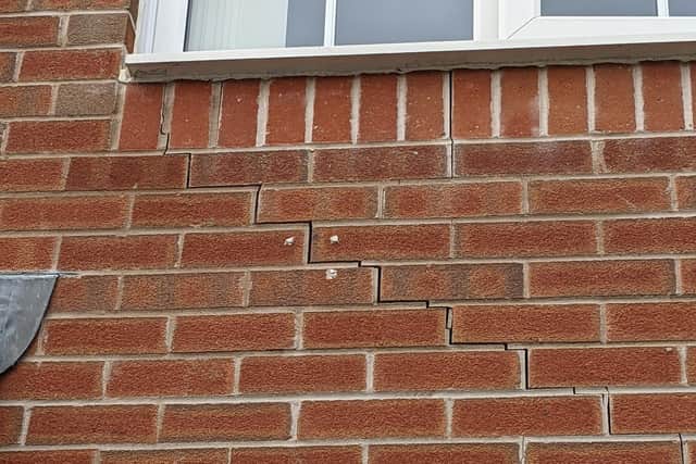 A crack in the outside, front wall of a Taylor Wimpey house in Crouch Hill Road