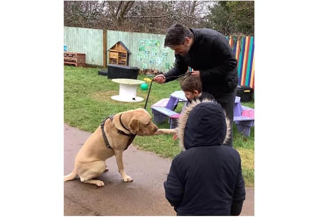 A new puppy called Dennis is helping to support students at Harriers Academy Banbury through boosting their wellbeing and companionship. He's pictured here with a few pupils and  Executive Principal Alex Pearson. (Submitted photo from the school)