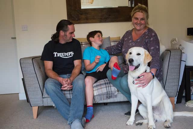 Michelle Spilsbury, husband Adrian and son Zach with their first Dogs for Good puppy Pasco