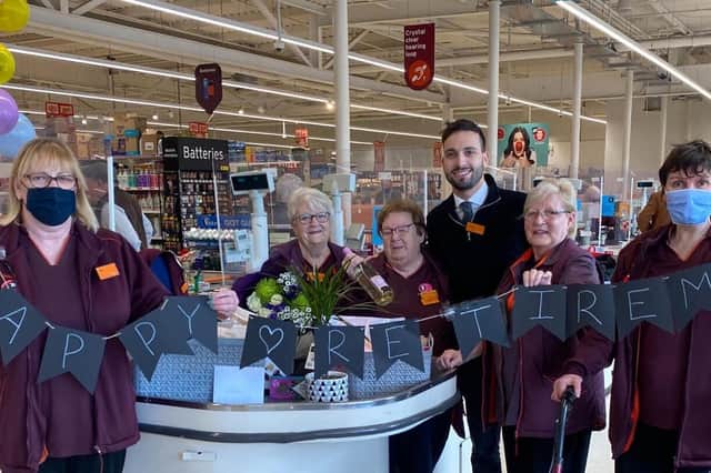 Elsie Francis, centre, is pictured with colleagues at her retirement from Sainsbury's Banbury store last Friday