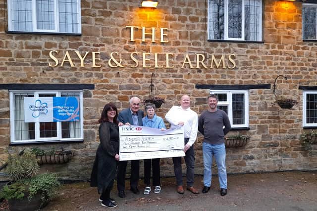 Brian Talbot, a long-time Banbury area quiz master, presented a cheque to officials with the Alzheimer's Society charity at an event held at the Saye & Sele Arms pub in Broughton near Banbury. (pictured Brian and Sheila Talbot at centre with Tim Waters from the Alzheimer's Society and Paul Hawkins-Rowe from the Saye & Sele Arms pub)
