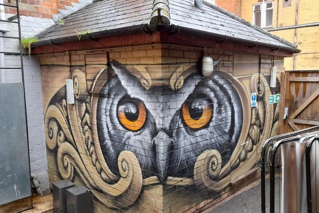 Large mural of an owl in the back garden of Rock the Atic, a late night bar in Butcher's Row of the Banbury town centre