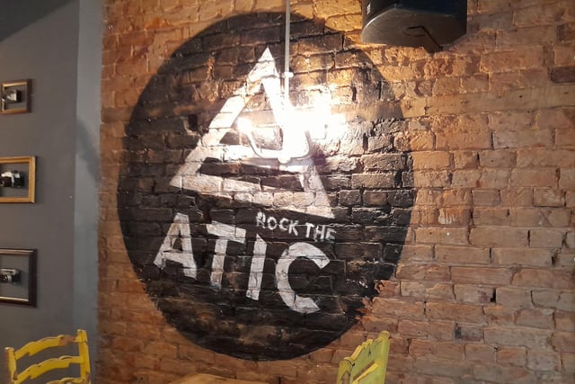 A mural of the logo for the late night bar and comedy club called Rock the Atic