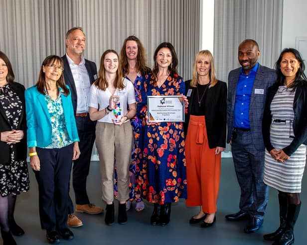The OUH Staff Wellbeing project team. Megan Tolson (middle left) from the Culture and Leadership team and Jackie Love (middle right) from Oxford Medical Illustration hold the Skills for Health award and certificate