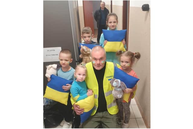 Ian Bathe, who grew up in Middleton Cheney, with several Ukrainian children who have all had their faces painted in the Ukrainian colours with the face paints he personally delivered to the border with his brother (submitted photo from Ian Bathe)
