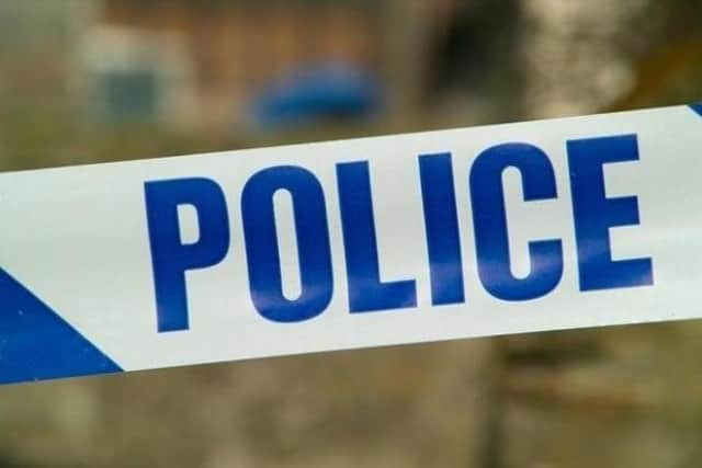 A man has been arrested on suspicion of attempted murder after a woman was attacked by an armed gang in a house in Bicester.