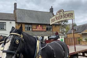 Commander and Lucas, the Shire horses, delivering beer to one of Hook Norton Brewery's pubs