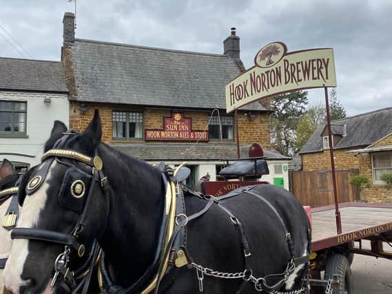 Commander and Lucas, the Shire horses, delivering beer to one of Hook Norton Brewery's pubs