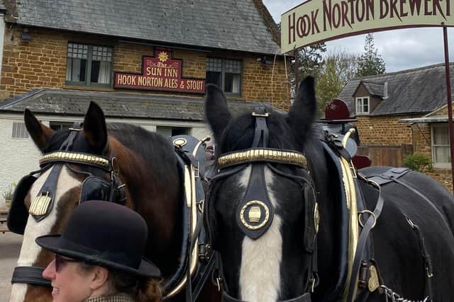 The Hook Norton Brewery dray with its Shire horses, Commander and Lucas, and groom Sarah Nash