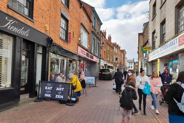 People walk down Parsons Street in the Banbury town centre