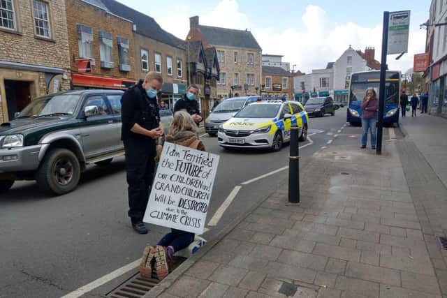 Thames Valley Police ask Rachel Payne, a member of Extinction Rebellion Banbury, to move to a safe area after she held a peaceful climate change protest in the high street.