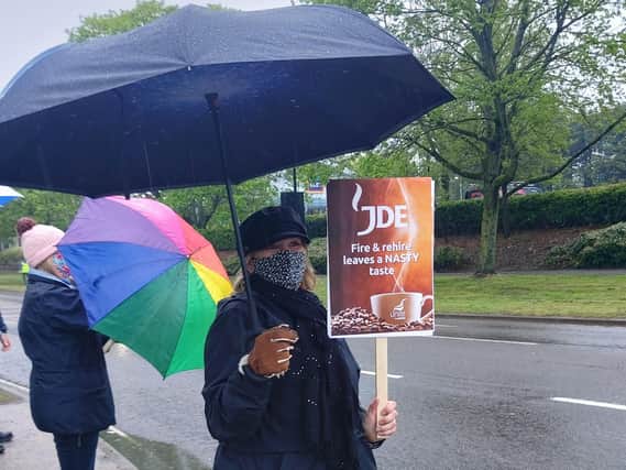 Protesters demonstrate during Saturday's rain but received plenty of support from passing motorists