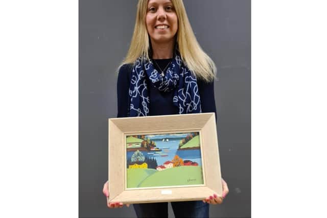 Sonya Marshall of Hansons with a Maud Lewis painting which sold for £10,000 (Image from  Hansons)