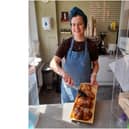 Sarah Thornber, the owner of Corner Cottage Bakery, holds a tray of Kanelbullar cinnamon rolls