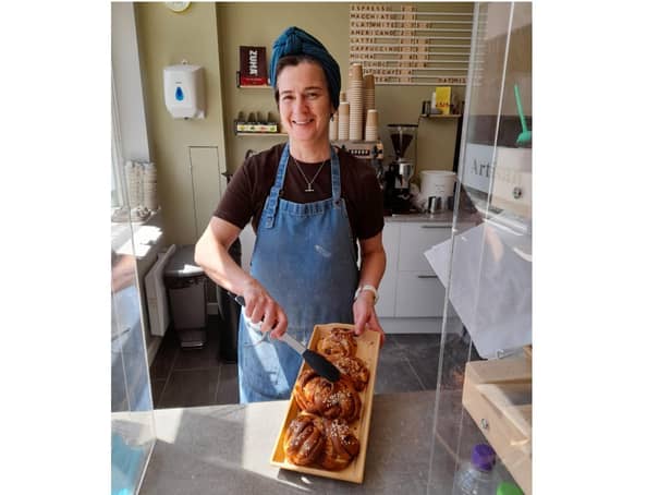 Sarah Thornber, the owner of Corner Cottage Bakery, holds a tray of Kanelbullar cinnamon rolls