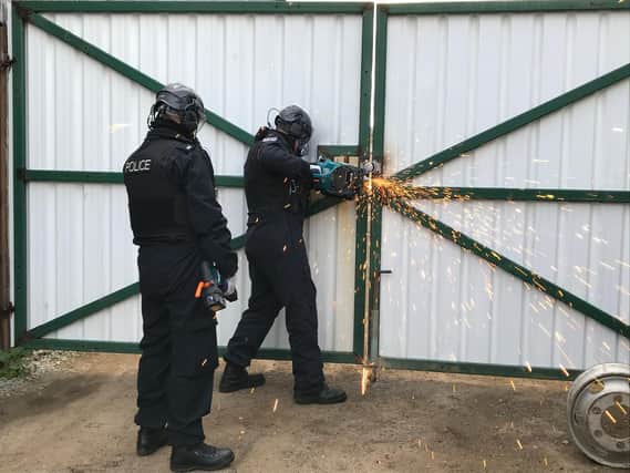 Thames Valley Police officers executing a warrant as part of an operation targeting organised crime and drug supply across the policing area, including Banbury (Image from TVP website)